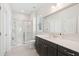 A spacious bathroom featuring a large vanity with a dark wood cabinet and glass enclosed shower at 307 Theus Pl, Huger, SC 29450