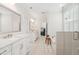 Bathroom featuring dual sinks, a large mirror, and access to a tub and walk-in shower at 307 Theus Pl, Huger, SC 29450