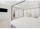 Bright bedroom with a four-post bed, TV, and ensuite bathroom with and sinks at 307 Theus Pl, Huger, SC 29450