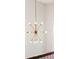 A bright, modern chandelier with multiple lights, mounted on a high, white ceiling at 307 Theus Pl, Huger, SC 29450