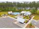 Aerial shot of community amenities, including a pool, clubhouse, sand volleyball and covered picnic area at 307 Theus Pl, Huger, SC 29450