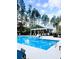 Community pool featuring plenty of lounge chairs, umbrellas and an open-air clubhouse at 307 Theus Pl, Huger, SC 29450