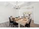 A dining room featuring a large table, black chairs, and a modern chandelier at 307 Theus Pl, Huger, SC 29450