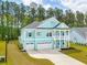 Stunning two-story home featuring a spacious three-car garage and charming porch at 307 Theus Pl, Huger, SC 29450
