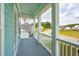 Inviting front porch with light blue ceiling and grey floors offers a great outdoor living space at 307 Theus Pl, Huger, SC 29450