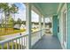 Inviting front porch with white railing and columns and light blue ceiling at 307 Theus Pl, Huger, SC 29450
