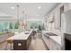 Bright, open-concept kitchen features an island, stainless appliances, and backyard access at 307 Theus Pl, Huger, SC 29450