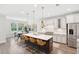 Bright kitchen with an island, counter seating, stainless steel appliances and modern lighting at 307 Theus Pl, Huger, SC 29450