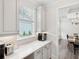 Kitchen area with white countertops, light grey cabinets, and access to the dining room at 307 Theus Pl, Huger, SC 29450