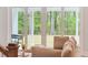 Bright living room with large glass doors overlooking fenced backyard and green trees at 307 Theus Pl, Huger, SC 29450