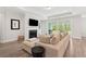 Living room with fireplace, modern furniture, hardwood flooring and backyard access at 307 Theus Pl, Huger, SC 29450