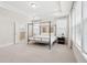 Bright main bedroom featuring a four-poster bed, neutral walls, and large windows at 307 Theus Pl, Huger, SC 29450