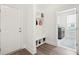 Mudroom with storage cubbies, wooden floors, and white door at 307 Theus Pl, Huger, SC 29450