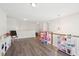 Large playroom with hardwood floors, toys, a play kitchen, and modern lighting fixtures at 307 Theus Pl, Huger, SC 29450
