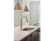A gold-colored faucet serves a sink on an island with white countertops and a dark base at 307 Theus Pl, Huger, SC 29450