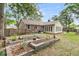 Spacious backyard with raised garden beds, mature trees, and sunroom addition at 31 Monte Sano Dr, Hanahan, SC 29410