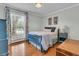 Charming bedroom featuring hardwood floors, light-blue walls, and natural light from a large window at 31 Monte Sano Dr, Hanahan, SC 29410