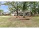 Well-maintained brick home with mature trees, blue shutters, and a landscaped front yard at 31 Monte Sano Dr, Hanahan, SC 29410