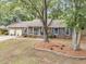 Charming brick home with blue shutters, mature trees, and landscaped front yard at 31 Monte Sano Dr, Hanahan, SC 29410