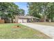 Brick home featuring a two-car garage, mature trees, and a landscaped front yard at 31 Monte Sano Dr, Hanahan, SC 29410