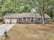Charming brick home with blue shutters, attached garage, and mature landscaping at 31 Monte Sano Dr, Hanahan, SC 29410