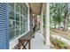 Covered front porch with seating and stately white columns at 31 Monte Sano Dr, Hanahan, SC 29410
