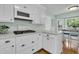 Clean kitchen featuring white cabinets, quartz countertops, hardwood flooring, and modern appliances at 31 Monte Sano Dr, Hanahan, SC 29410
