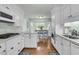 Well-equipped kitchen featuring white cabinets, countertops and a view into the dining area at 31 Monte Sano Dr, Hanahan, SC 29410