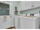Bright laundry room featuring modern washer and dryer, white cabinets, and stylish decor at 31 Monte Sano Dr, Hanahan, SC 29410