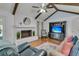 Bright living room boasts vaulted ceiling with beams, and a brick fireplace with a round mirror at 31 Monte Sano Dr, Hanahan, SC 29410