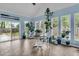 Bright sunroom with windows overlooking backyard, brick floors and plants at 31 Monte Sano Dr, Hanahan, SC 29410