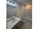 Well-lit bathroom featuring a shower-tub combo, a single sink vanity, and tiled floors at 3218 Pinewood Dr, Ladson, SC 29456