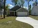 Charming single-story home with a two-car garage, well-manicured lawn, and a concrete driveway at 3218 Pinewood Dr, Ladson, SC 29456