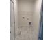 Neat laundry room with washer/dryer hookups, overhead shelving, and stylish flooring at 3222 Pinewood Dr, Ladson, SC 29456