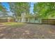 Large backyard with lawn and fence, with home exterior visible with mature shade trees at 3230 Landing Pkwy, North Charleston, SC 29420