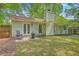 Relaxing backyard features a patio and a lush green lawn and wooded fence at 3230 Landing Pkwy, North Charleston, SC 29420