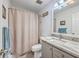 Neat bathroom with shower curtain, gray vanity, white toilet and patterned countertop at 3230 Landing Pkwy, North Charleston, SC 29420