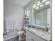 Clean bathroom with marble countertops, white cabinets and toilet, and a shower curtain at 3230 Landing Pkwy, North Charleston, SC 29420