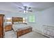 Well-lit bedroom features a wooden bed frame, lamps, and neutral paint color at 3230 Landing Pkwy, North Charleston, SC 29420