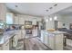 Well-lit kitchen features stainless steel appliances, granite countertops and an island with pendant lighting at 3230 Landing Pkwy, North Charleston, SC 29420