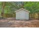 Backyard shed with wooden door, and fence, nestled amongst mature shade trees at 3230 Landing Pkwy, North Charleston, SC 29420