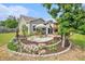 Landscaped backyard with a picnic area, deck, and flower garden at 3319 Dunwick Dr, Johns Island, SC 29455