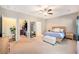 Spacious bedroom featuring a walk-in closet, a wooden bed frame, and neutral carpeting at 3319 Dunwick Dr, Johns Island, SC 29455