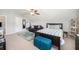 Bedroom features a large bed, a turquoise rug, a sofa, and storage beneath the sloped ceiling at 3319 Dunwick Dr, Johns Island, SC 29455