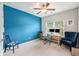 Well-lit office space features an accent wall, a ceiling fan, and dual monitors setup at a desk at 3319 Dunwick Dr, Johns Island, SC 29455