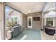Relaxing screened-in porch featuring a dartboard and stylish furnishings at 3319 Dunwick Dr, Johns Island, SC 29455