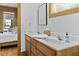 Bathroom with double vanity, wood cabinets, and a view into the Primary bedroom at 3320 Myrtle St, Edisto Island, SC 29438