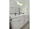 Bathroom features double vanity, light countertops, dark fixtures and a large mirror at 3320 Myrtle St, Edisto Island, SC 29438