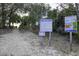 Path to beach access and informational signs in a natural setting at 3320 Myrtle St, Edisto Island, SC 29438