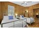 Bedroom features two beds, wood walls, nice natural light and ceiling fan at 3320 Myrtle St, Edisto Island, SC 29438
